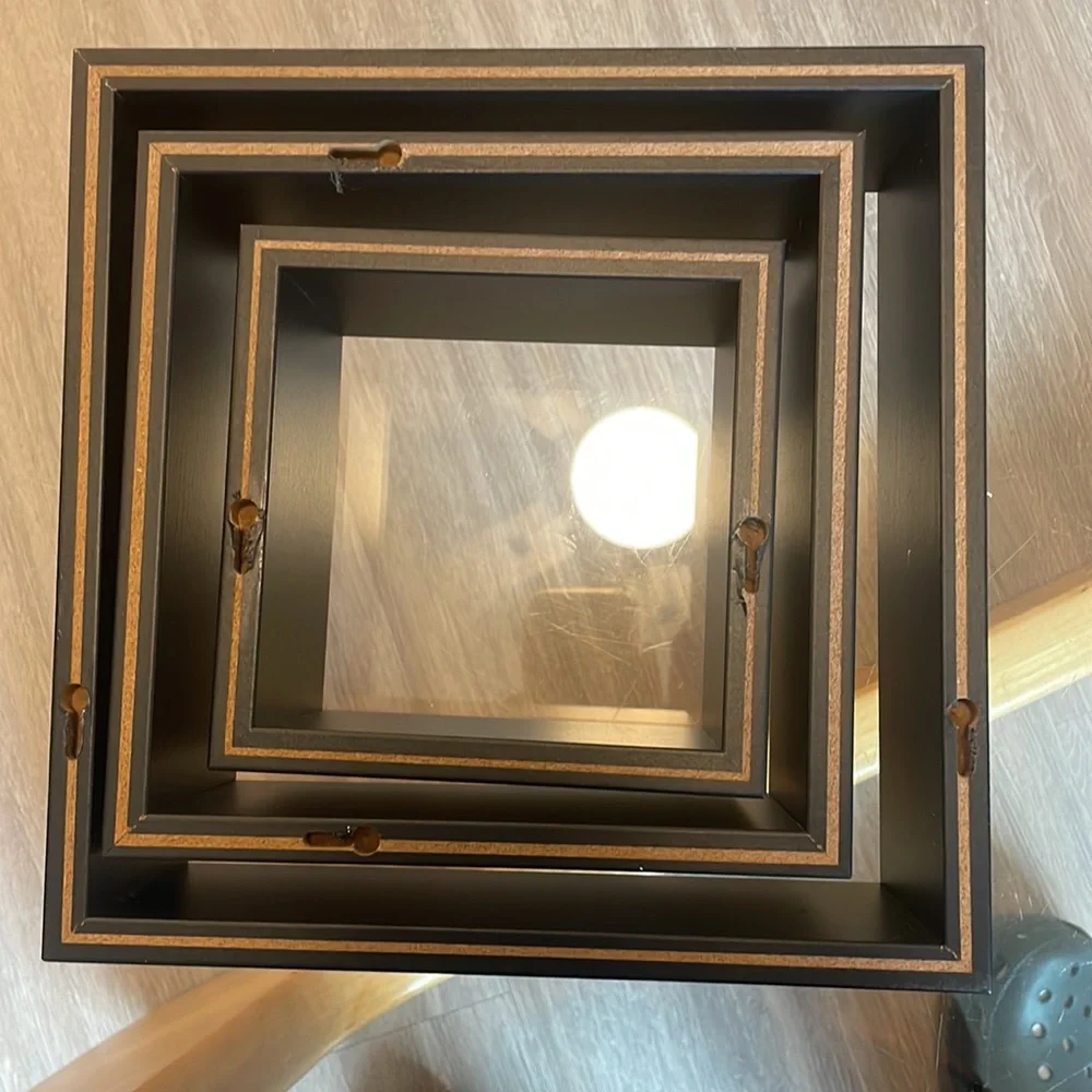 3 black shelving units